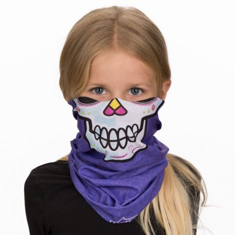 A young girl wearing a face mask of a sugar skull on purple fabric