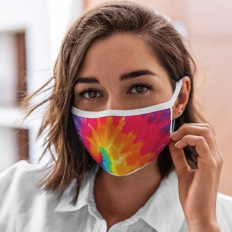model wearing an ear loop face mask in multi color overlapping lines with white trim